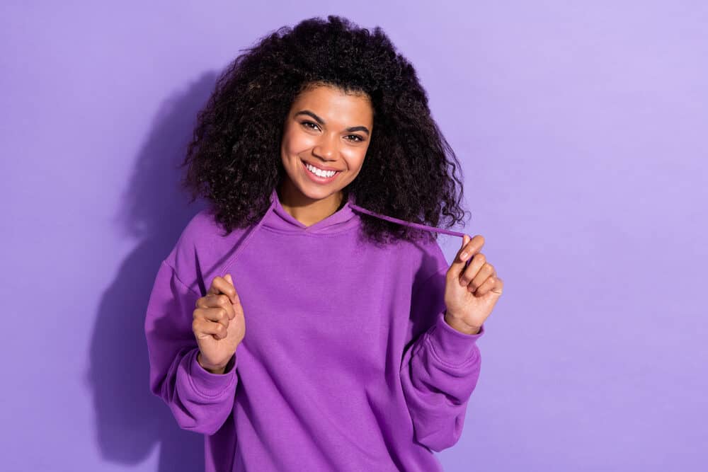 Young African American female wearing a wash and go after using Head and Shoulders shampoo.