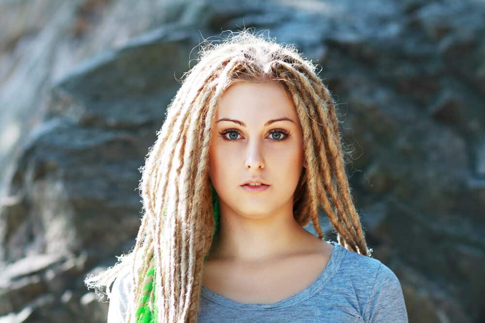 A young white student with blonde dreadlocks created by backcombing her 1B normal hair which is straight.