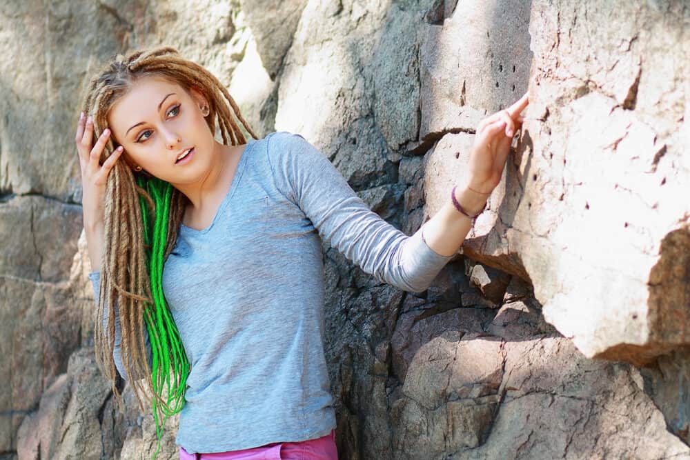 Young white woman with dreadlocks similar to those worn by a black woman from the Rastafarian culture.