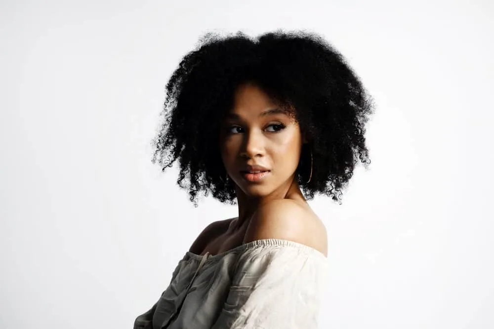 Does Vegamour Work for Hair Loss? Thinning Hair? Alopecia? 5 A cute black girl wearing 4A curls after using Vegamour hair serum to combat thinning hair follicles.