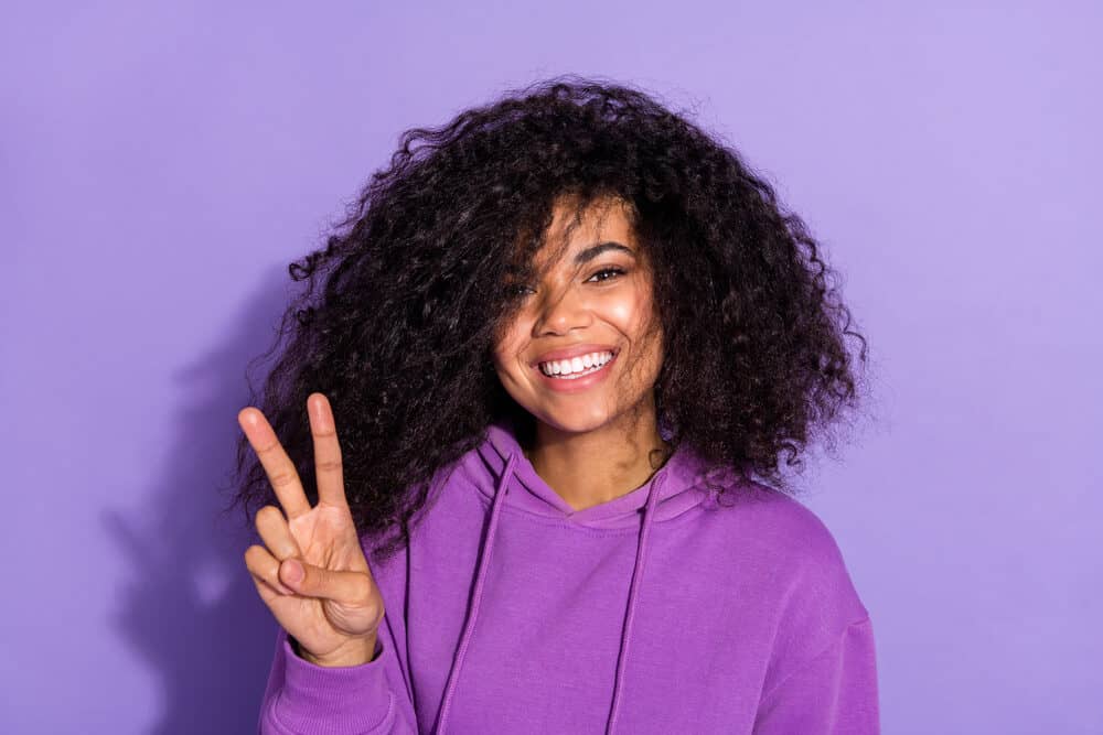 Adorable African American girl with 4A natural curls wondering if scalp irritation will cause her to lose hair density.