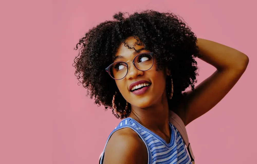 How Much Does Hair Weigh? How Can You Weigh Your Hair 2 Black lady with 4A curly hair follicles with medium hair thickness on very long hair wearing a blue shirt.