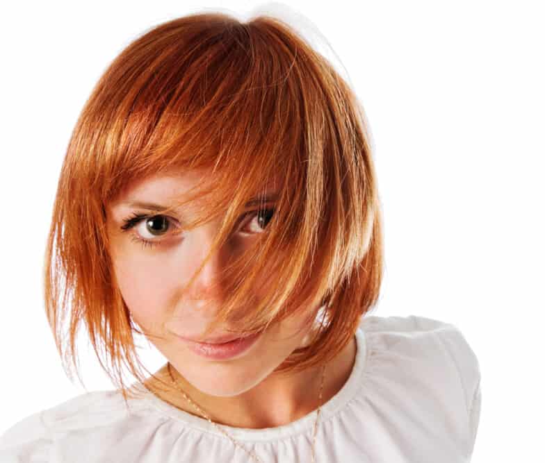 Beautiful young white female with a brassy orange hair color with a cute bob hairstyle.