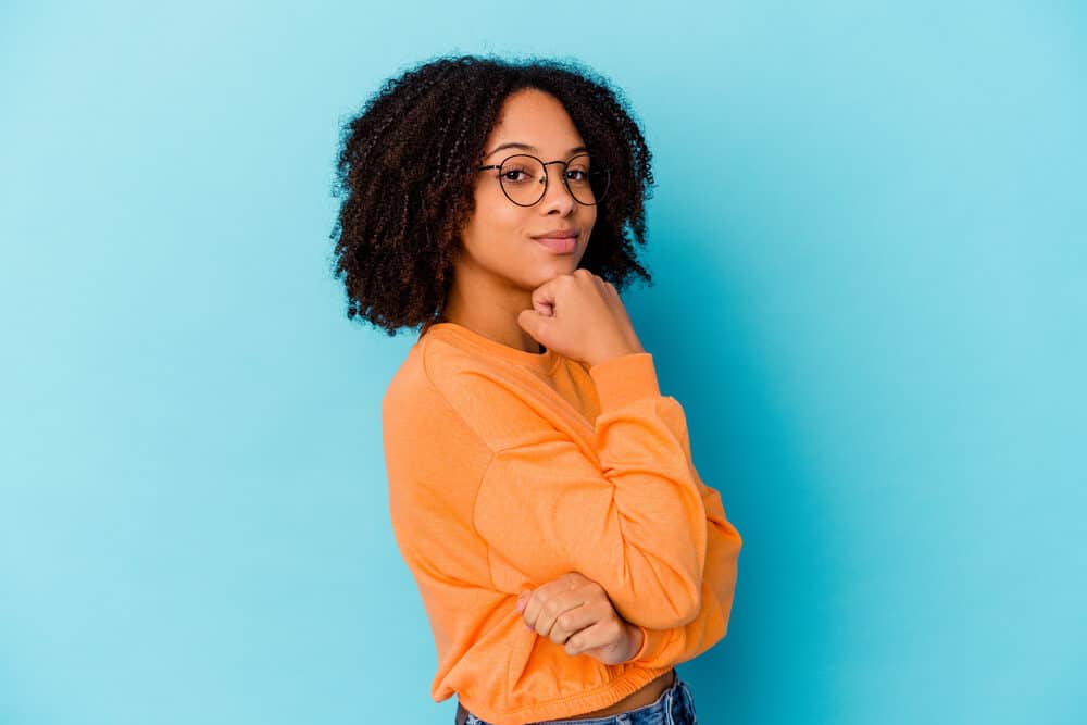 A cute female enjoying her terrific hair health after taking advantage of the many sea moss benefits for hair.