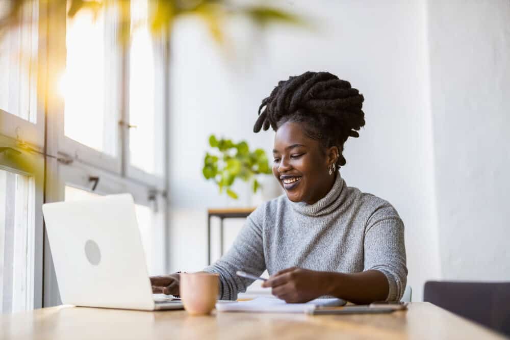 Black girl with natural freeform dreads maintained by re-twisting thicker locs together to minimize breakage.