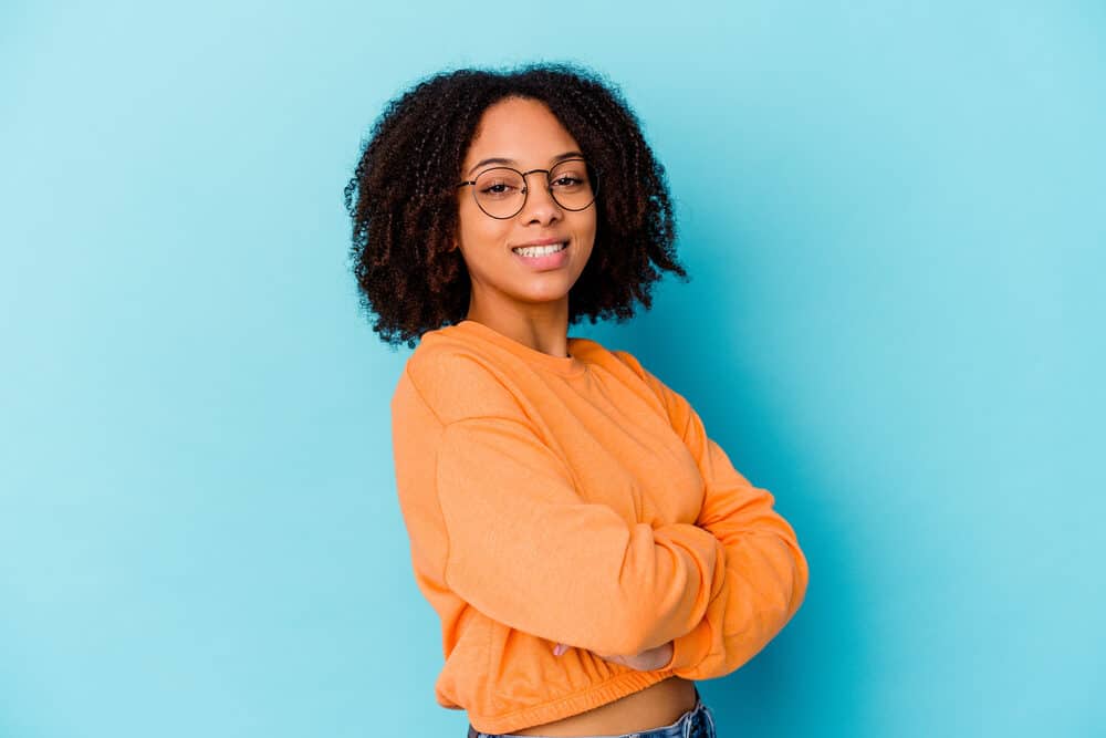 Cute African American female with 3C curls treated with Irish sea moss and olive oil to promote hair growth.