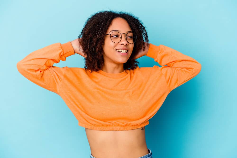 A lady admiring her outstanding hair and scalp health after using dried sea moss to promote skin repair and growth.