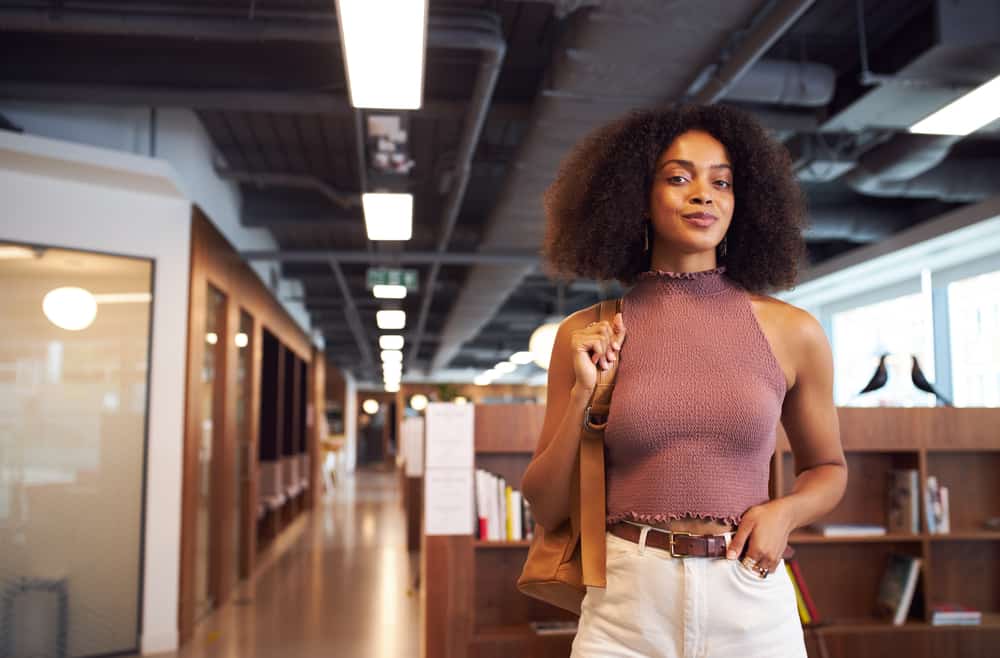 African American female wearing casual clothes with kinky curly wash and go hairstyle.