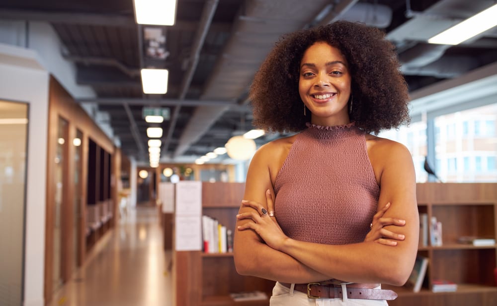 African American businesswoman with naturally brown hair that has red-brown shades after using Arctic Fox dye.