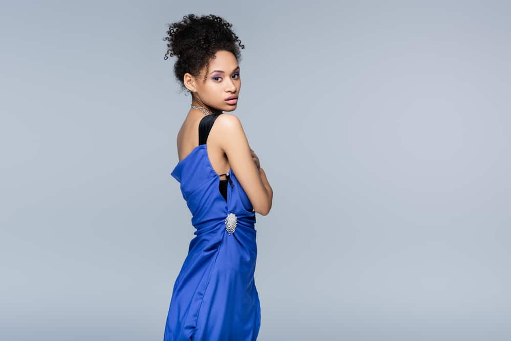 Cute black girl ready for a stress-free wedding day wearing a blue bridesmaid dress for her friend's wedding.