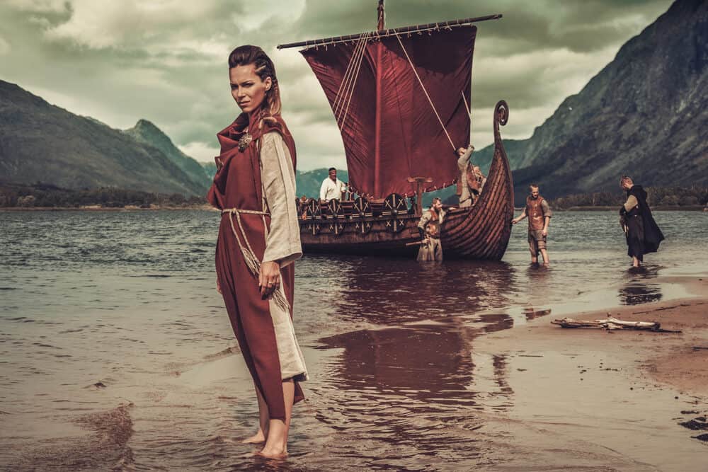 Cute Viking female wearing dreadlocks and old ragged clothing.