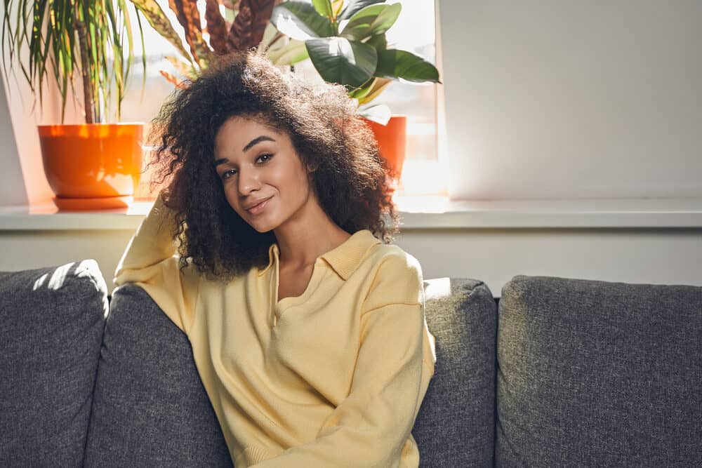 Cute black girl with a wash n go hairstyle created with a sulfate-free shampoo, coconut oil, and a wide-tooth comb.