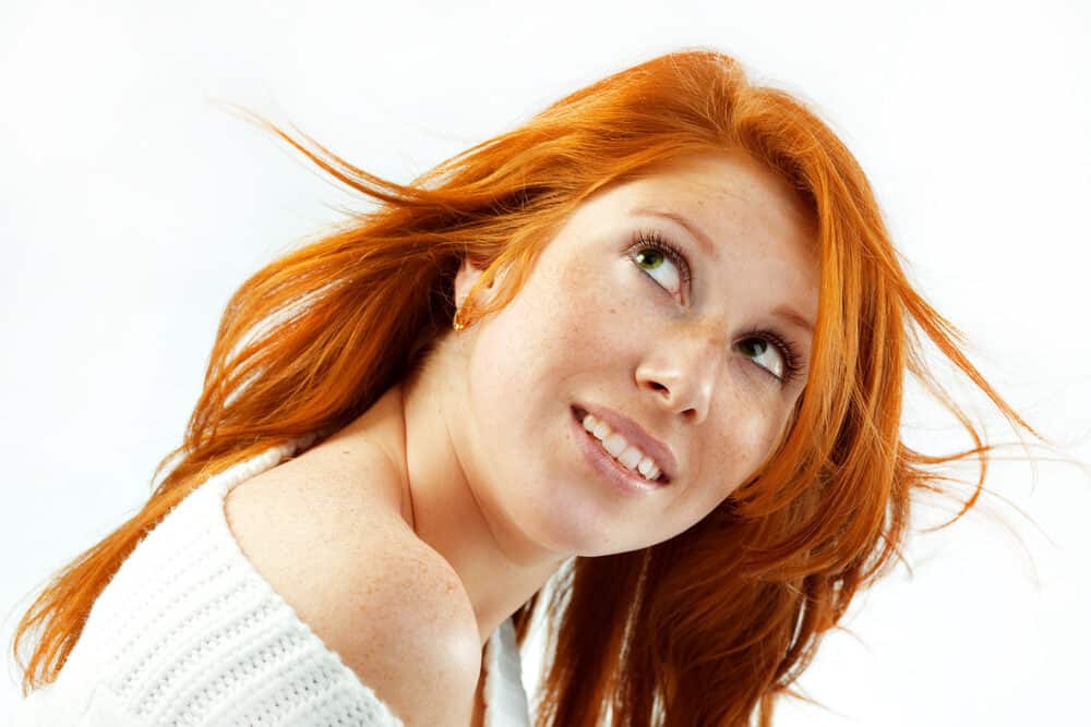 Young Caucasian female with green eyes and natural blonde hair that's been dyed with ash blonde hair dye.