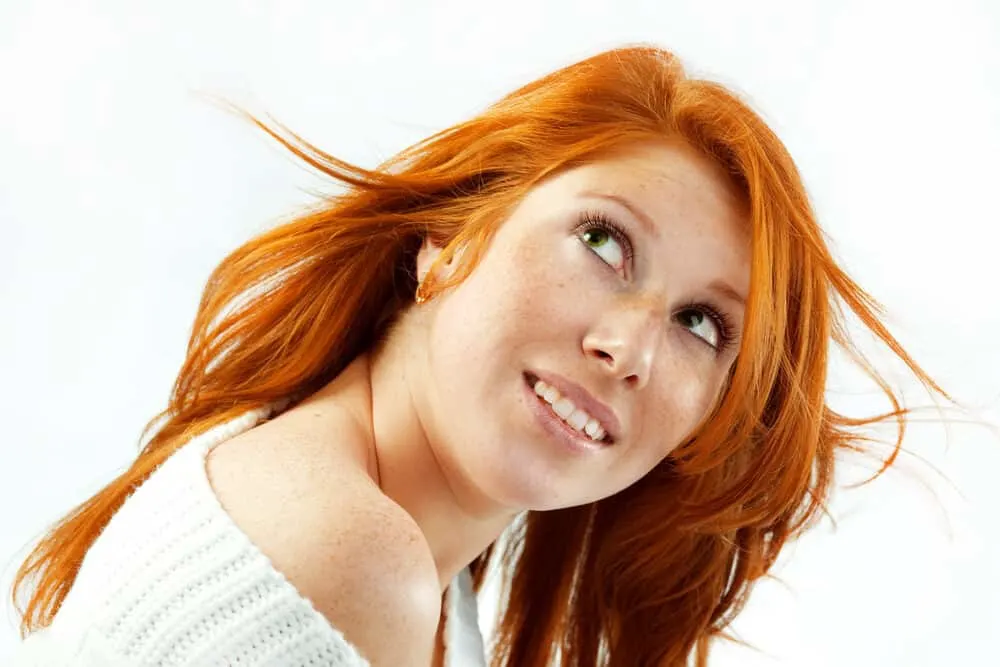 What Color Covers Orange Hair? Brassy? Dye? After Stripping? 2 Young Caucasian female with green eyes and natural blonde hair that's been dyed with ash blonde hair dye.