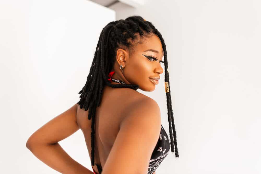 Young black woman wearing a popular hairstyle while making a fashion statement with a unique style.
