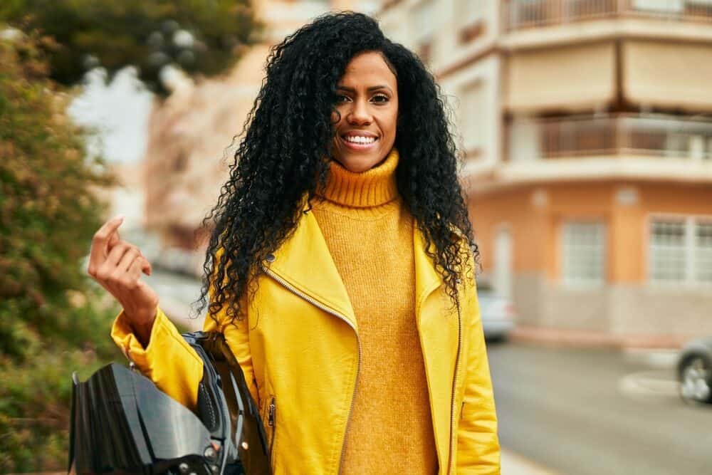 50-year-old black lady with a sensitive scalp wearing a frontal wig to give her thicker longer hair.