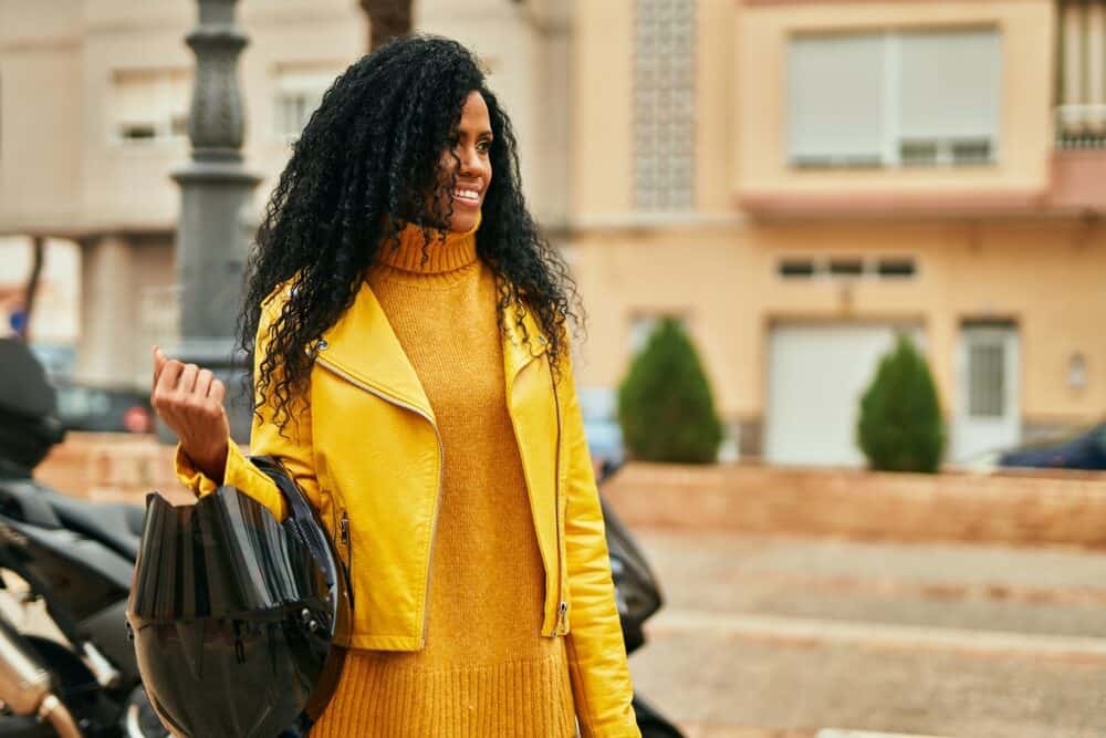 Black lady with caramel skin complexion wearing a lace wig to cover bald patches and growing hair loss. 