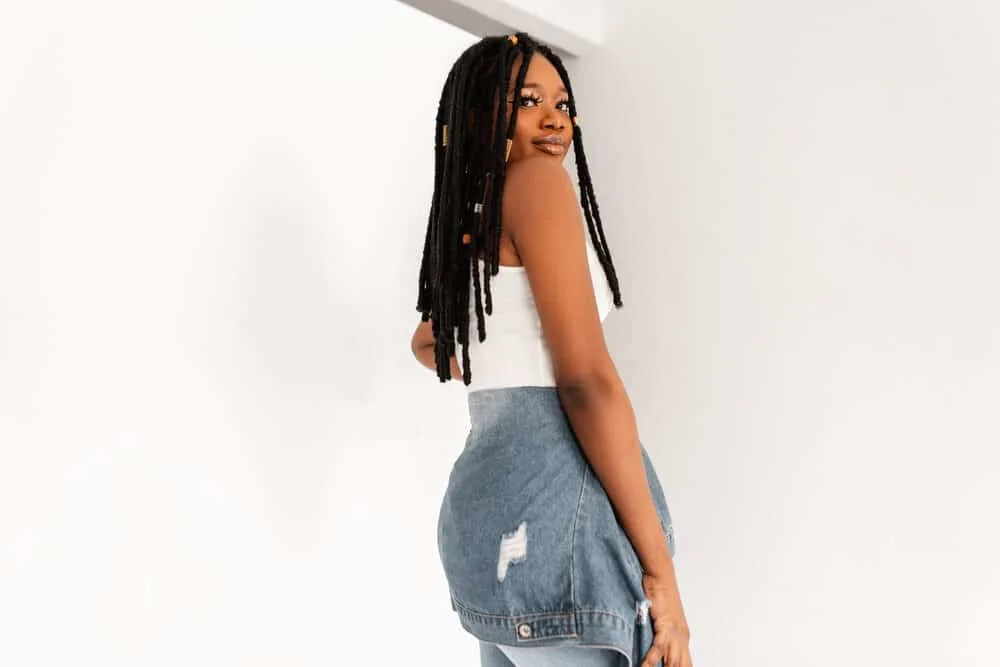 Where Did Dreadlocks Originate? The True History of Dreadlocks 10 Trendy African American woman with dreadlocks wearing a casual denim outfit.