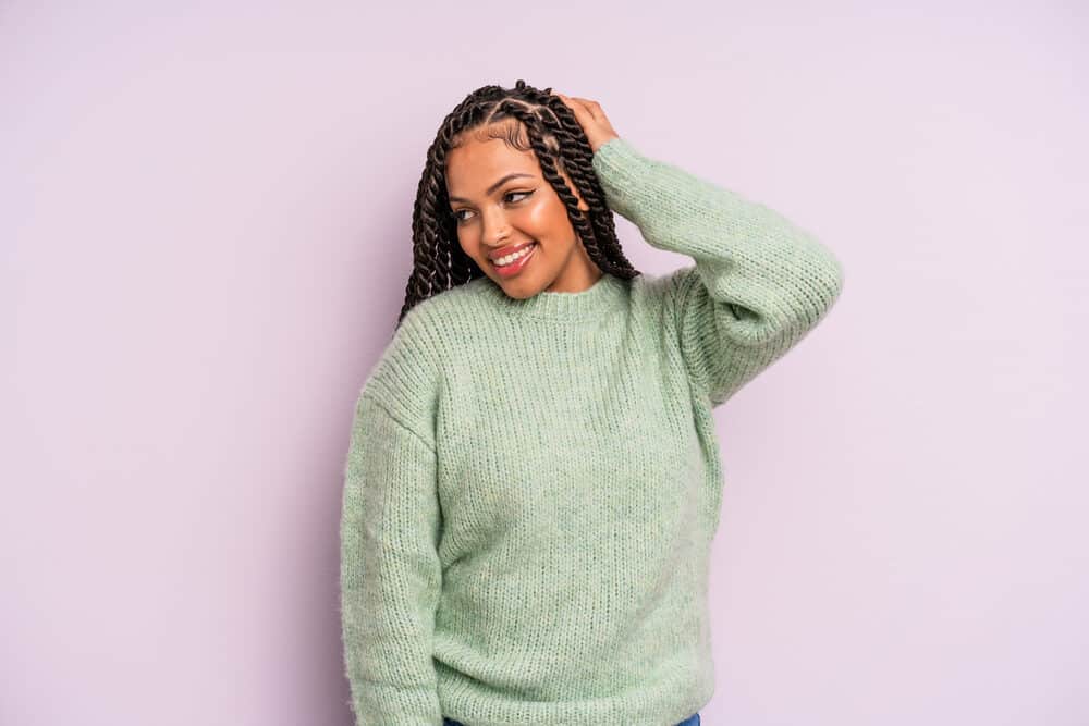 A Latina female wearing box braids that could be enhanced with colorful highlights.