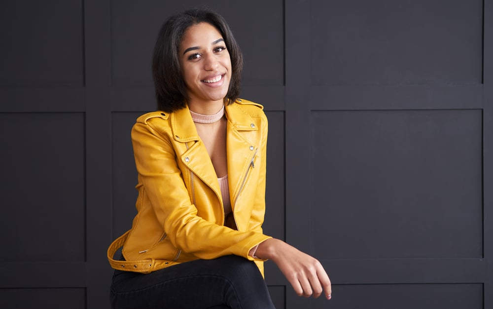 Stunning young African American female with straight hair that was recently styled with a hair dryer.