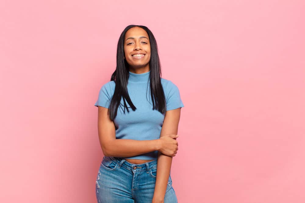 Cute young woman with a straight style after letting her hair air dry and using a high-temperature flat iron.