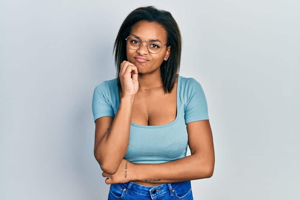 Young adult female with straightened hair after using a blow dryer and other heated styling tools.