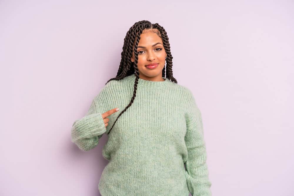 Latina wearing seven Mexican braids with face-framing tendrils that can be easily styled into traditional low braids.