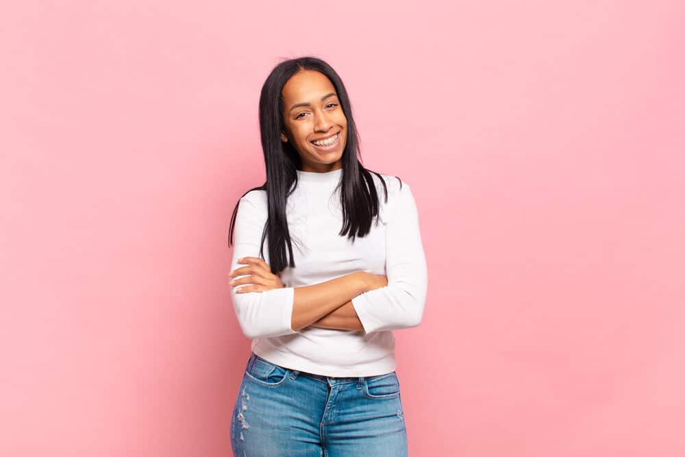 Young African American female with straight hair strands created with a hair straightener on type 4 fine hair.