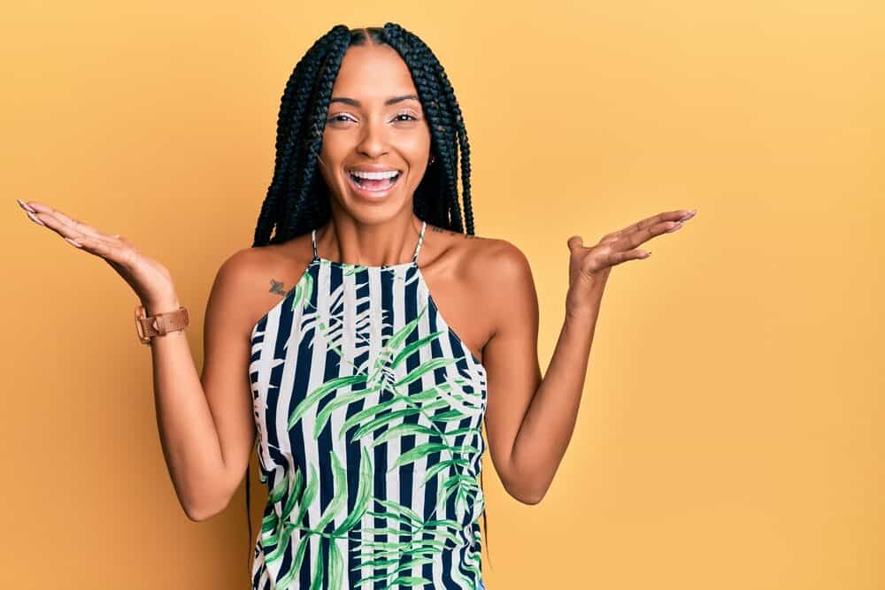 Cute Hispanic woman wearing a fun summer dress after exfoliating her scalp with baking soda and braiding her hair.