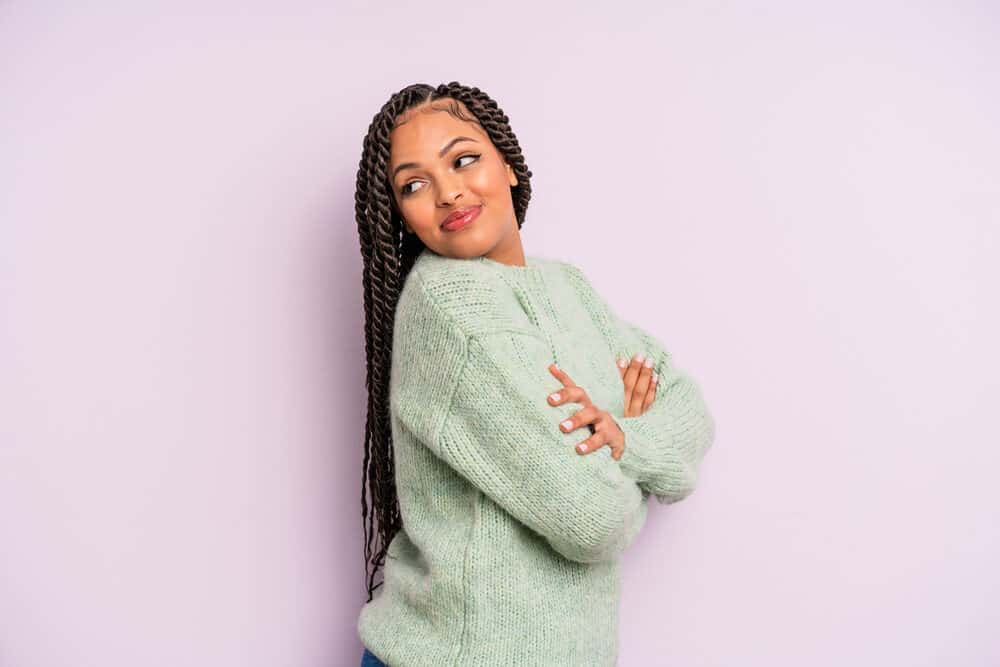 Cute Mexican female with long hair wearing a braided hairstyle that conforms to her oval face shape.