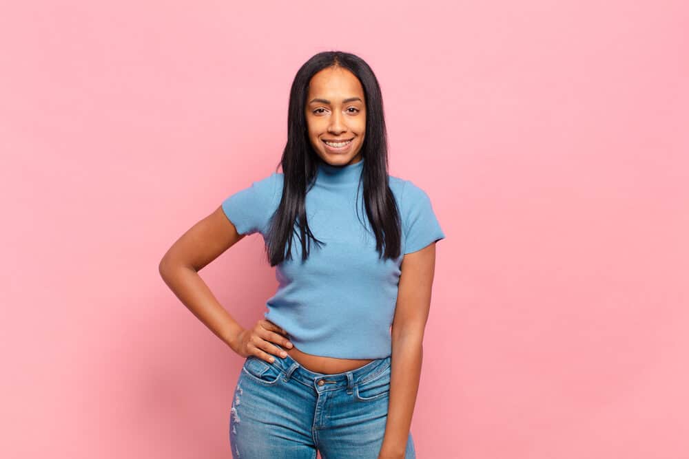 Young black female with a straight hair texture that experiencing hair breakage from excessive heat styling.