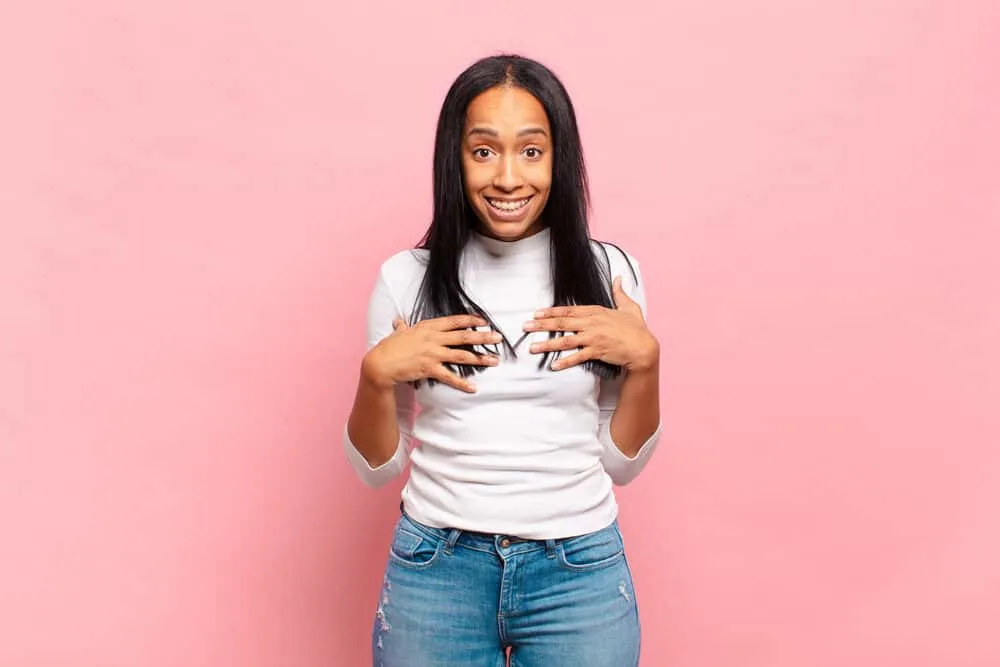 Can You Use Hairspray Before Straightening Your Hair? 6 Black woman with a type 4 hair type is wearing her hair completely dry after straightening it.