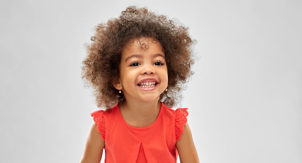 Beautiful African American kid with naturally curly hair.