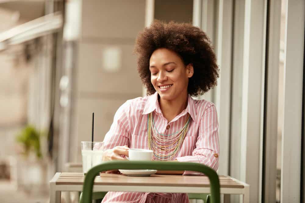 Mixed-race female with a natural olive skin tone wearing brown colored hair that pairs well with darker skin tones.