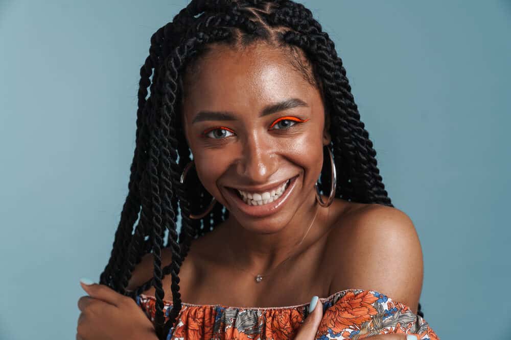 Gorgeous African American female with 4B natural hair follicles wearing her hair in a braided protective style.