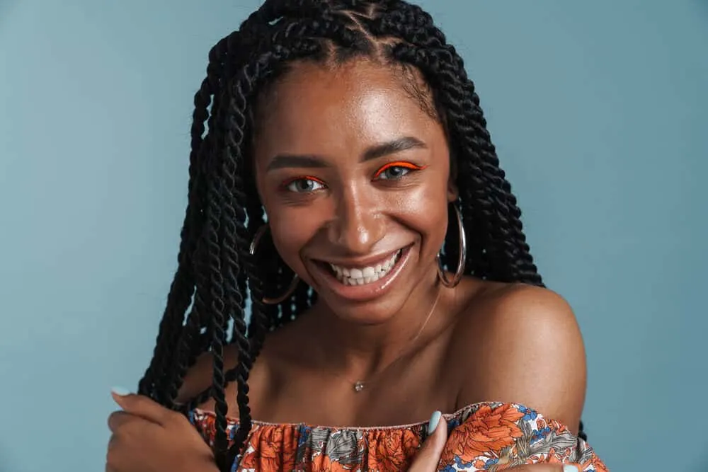 How To Clean Braided Hair Without Washing or Ruining Your Braids 1 Gorgeous African American female with 4B natural hair follicles wearing her hair in a braided protective style.