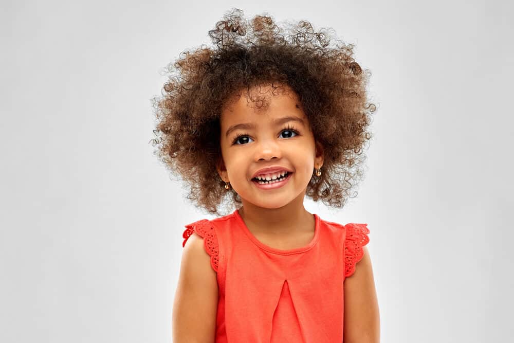 Adorable African American girl with a stray eyelash in her big black baby eyes that are stunning.