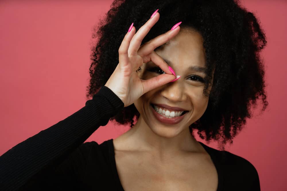 Lady that recently started her natural hair journey showing off her natural curls created with non-protein products.