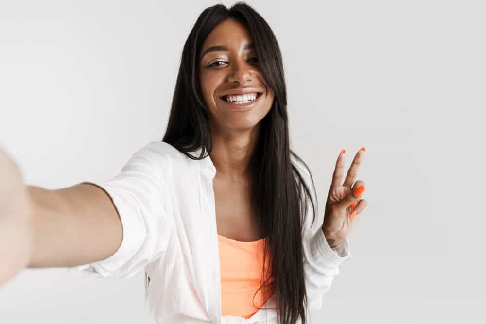 Black woman wearing a human hair lace front wig purchased at a wig outlet to cover up some minor hair loss.