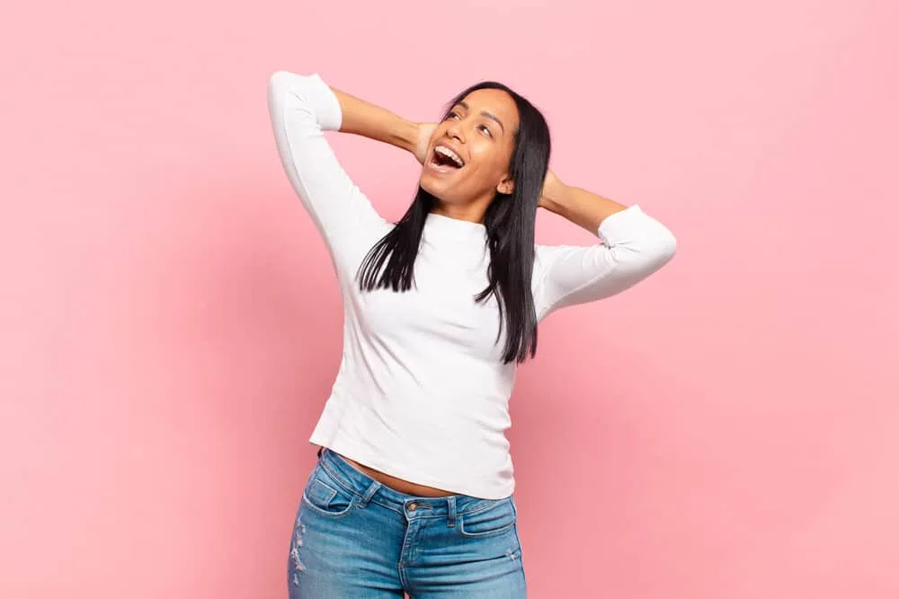 Can You Use Hairspray Before Straightening Your Hair? 3 Young African women with bone dry hair after using a flat iron with ceramic plates and a light-hold hairspray.