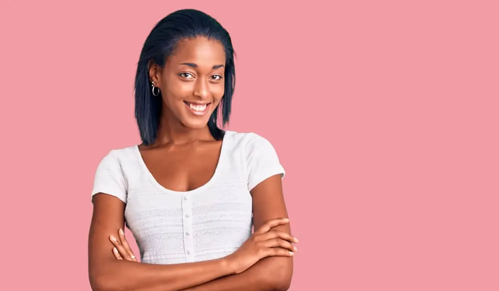 Best Steam Straighteners for Black, Curly, and Natural Hair 14 A lady wearing a white shirt after steaming her natural curls with a steam flat iron with ceramic tourmaline plates.