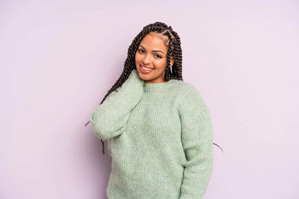 Mexican Braids: Are Braids Part of Mexican Culture? 1 Mexican female mixed with African descent with thick hair in medium braids wearing a green sweater.