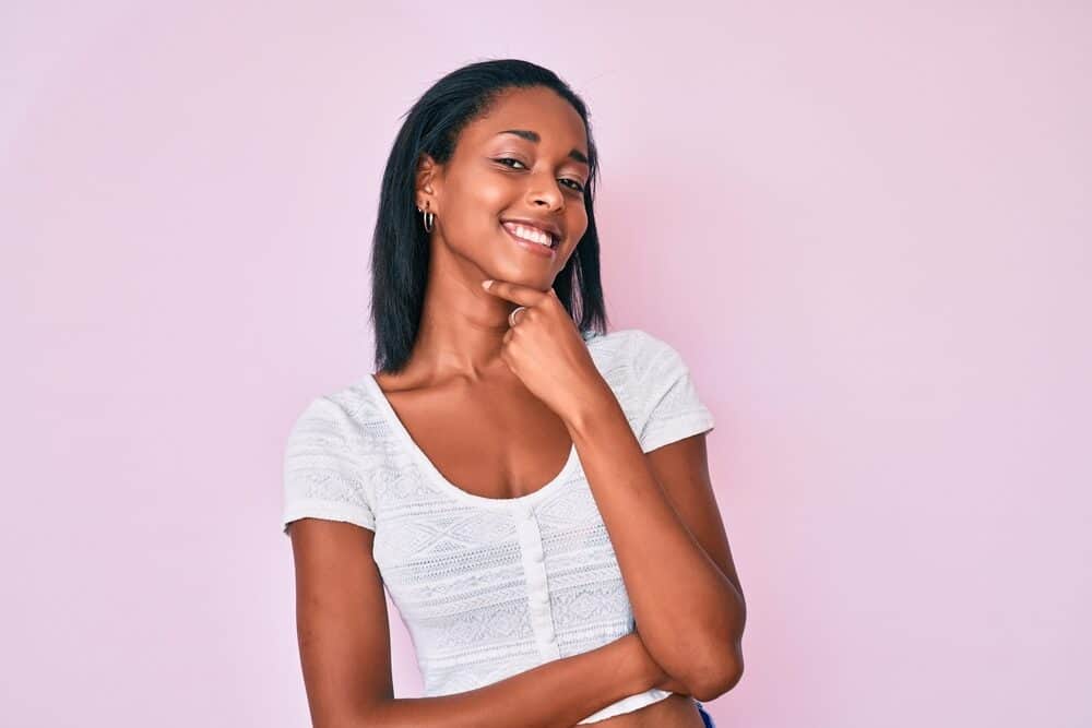 Black woman with a 4A hair type after styling her hair with a metal-ceramic heater with vapor infusion technology.