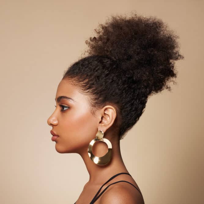 Gorgeous African American female with cute brown hair color created chocolate hair dye and bleach powder.
