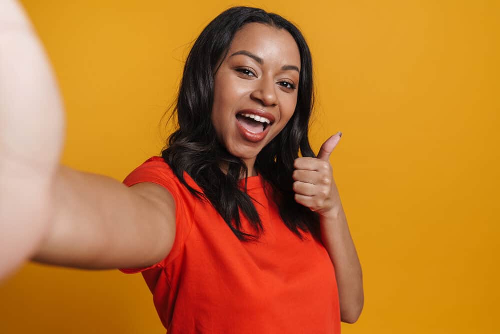 African American girl that avoided flat iron damage by using low-heat on her thermally straightened hair.