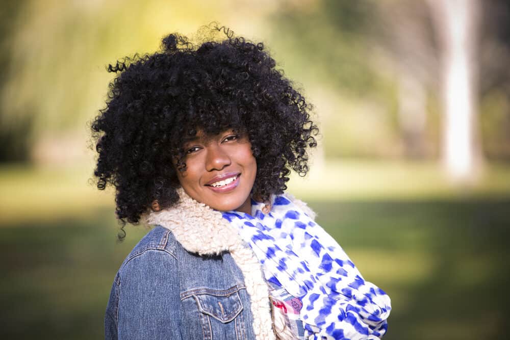 An adult female with healthy human hair wearing a natural hair wig to change up her appearance.