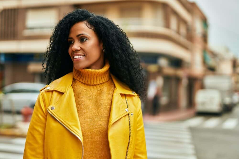 Older black female with 4C natural hair wearing human hair extensions attached to her hair follicles with wig clips.