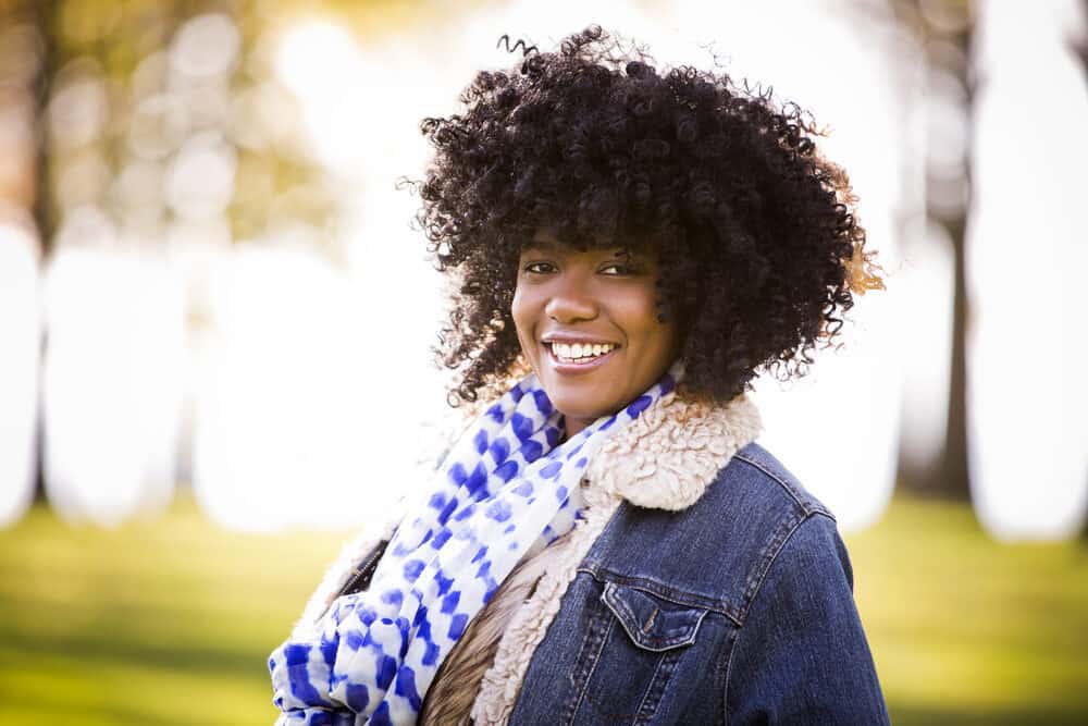 African American woman with thinning hair wearing an artificial hair wig covering her own hair.