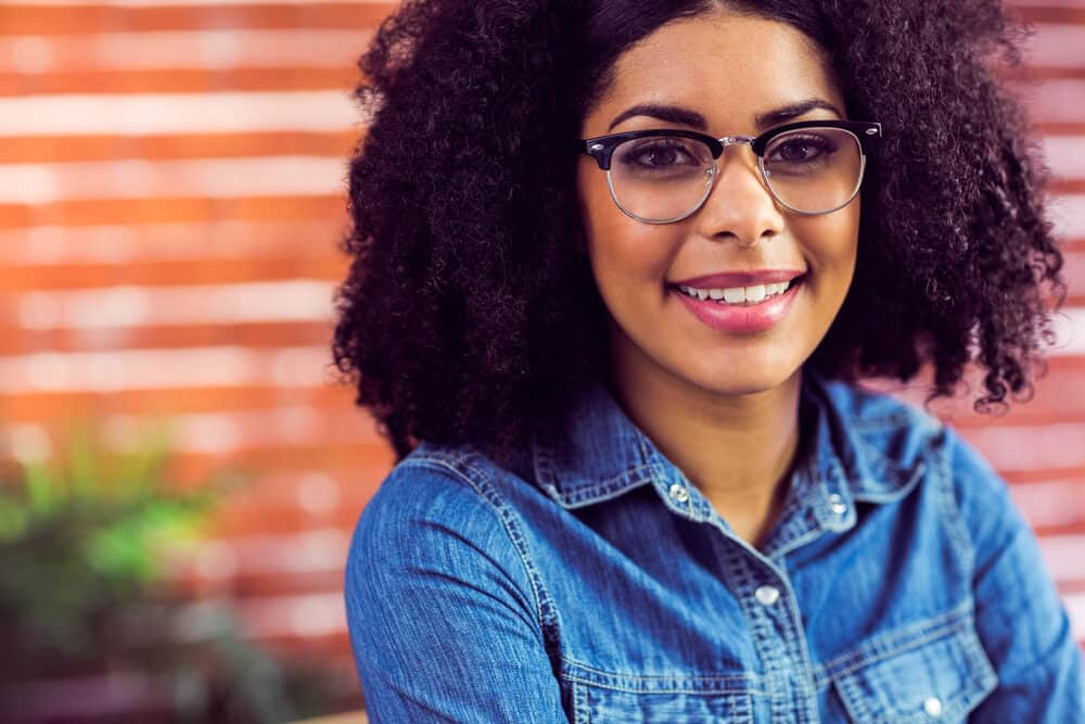 Cute African American female with a natural appearance wearing a low-maintenance hairpiece.