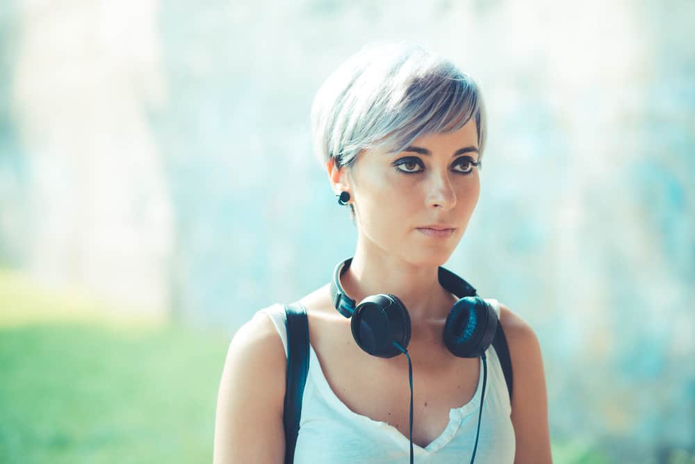 A beautiful young lady with a pale skin tone and light brown hair dyed with black sapphire hair dye.